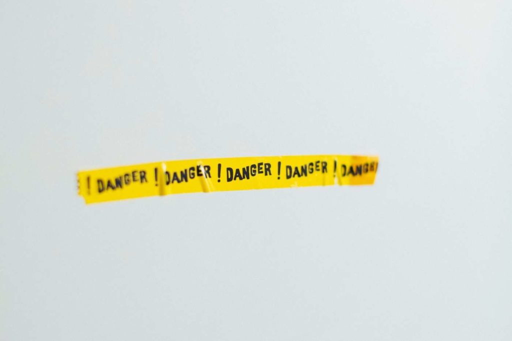 Danger tape stuck to a wall warning against falling victim to rental scams