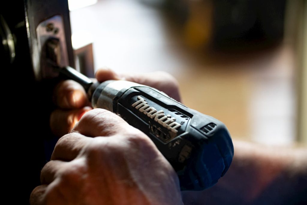 A handyman doing maintenance to a Portland Rental Home