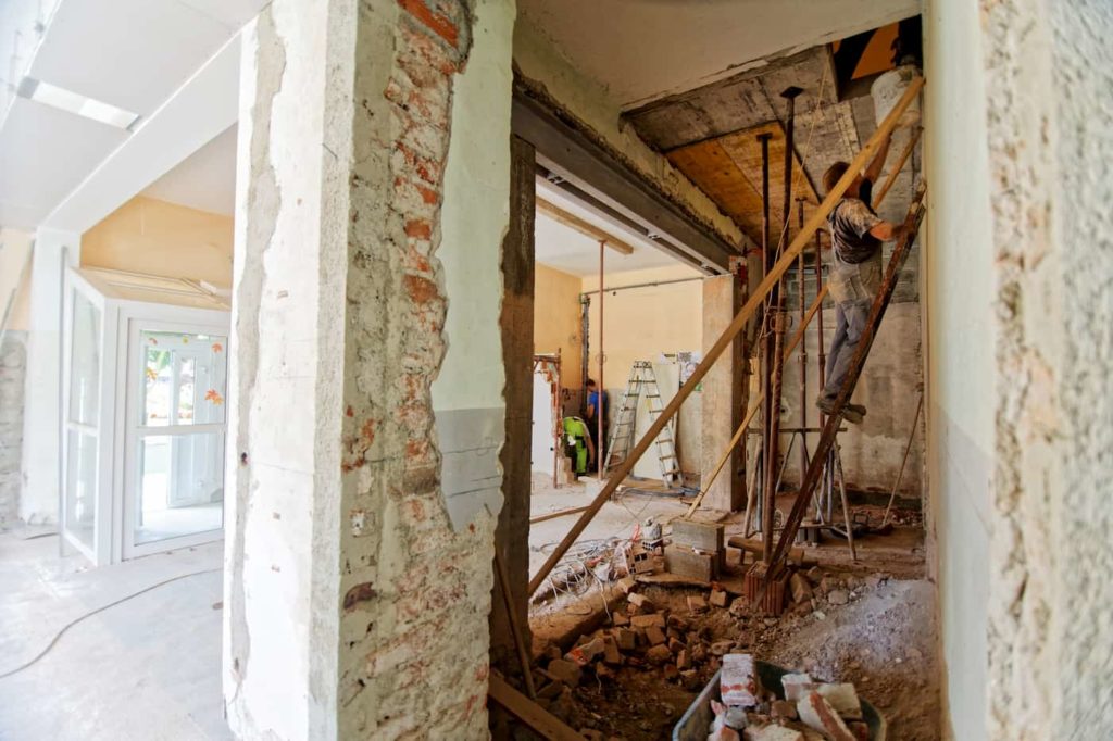 A construction crew remodeling the interior of an investment property