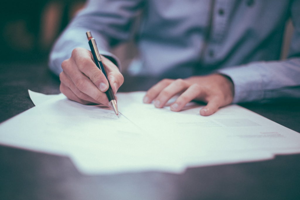 Man filling out rental screening forms.