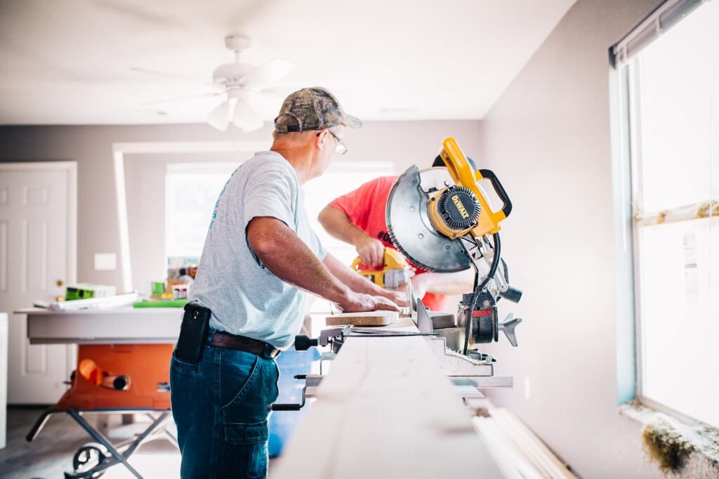 Two men working on rental property upgrades