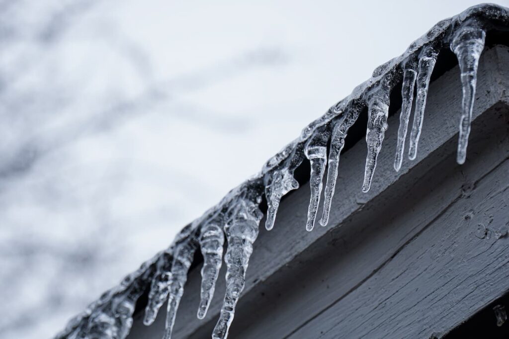 ice forming on a roofline during a winter storm