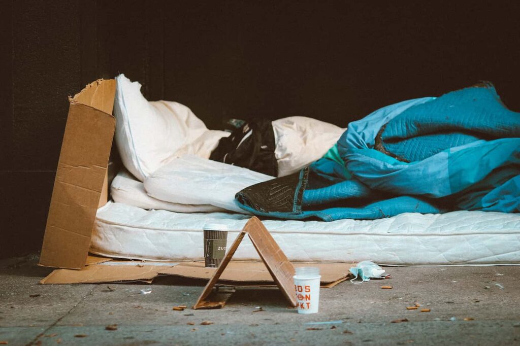 A makeshift bed set up on a city street