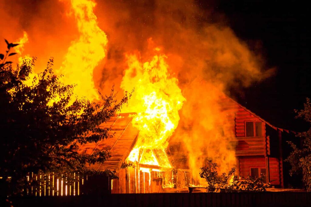 A home being consumed by the flames from wildfires