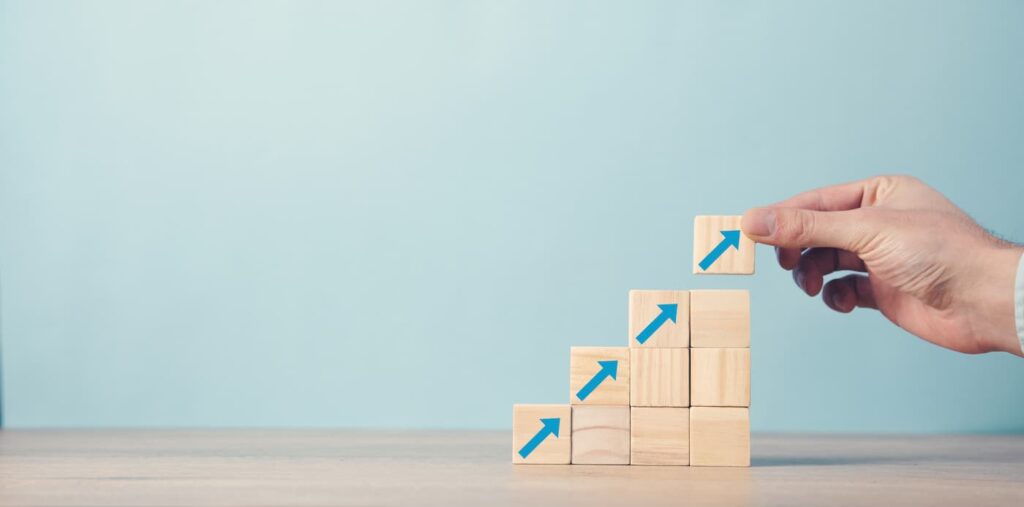 A staircase built of wooden blocks with arrows printed on them representing the Oregon rent increase.