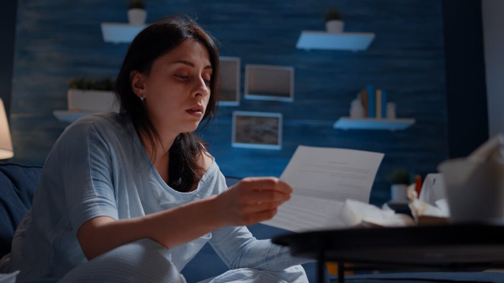 A landlord holds up a piece of paper while wondering how to manage tenant disputes.