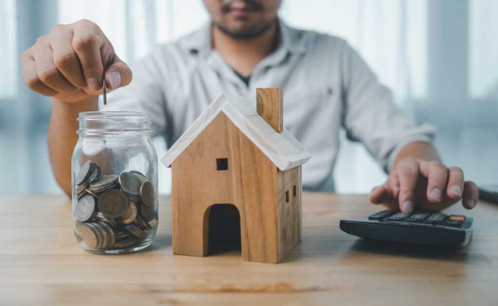 A landlord places money in a jar while wondering how to manage rent increases fairly.