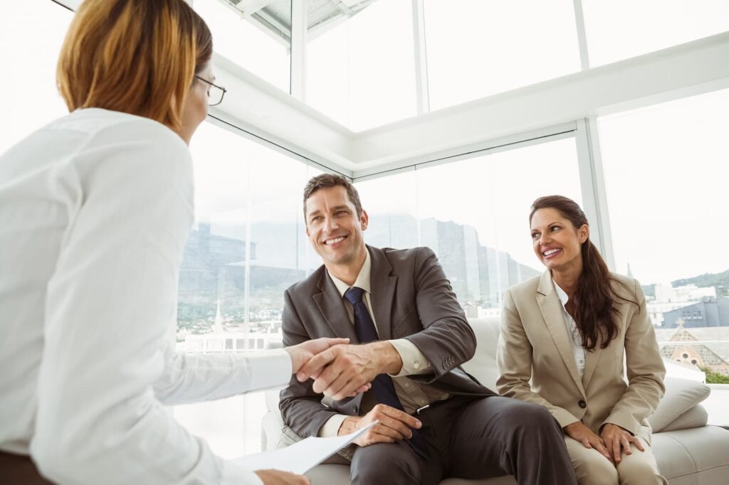 A person shakes hands while hiring property management staff members.