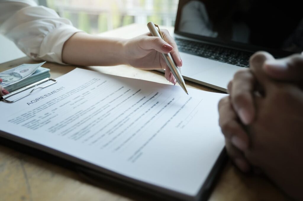 a picture of two people signing a lease agreement