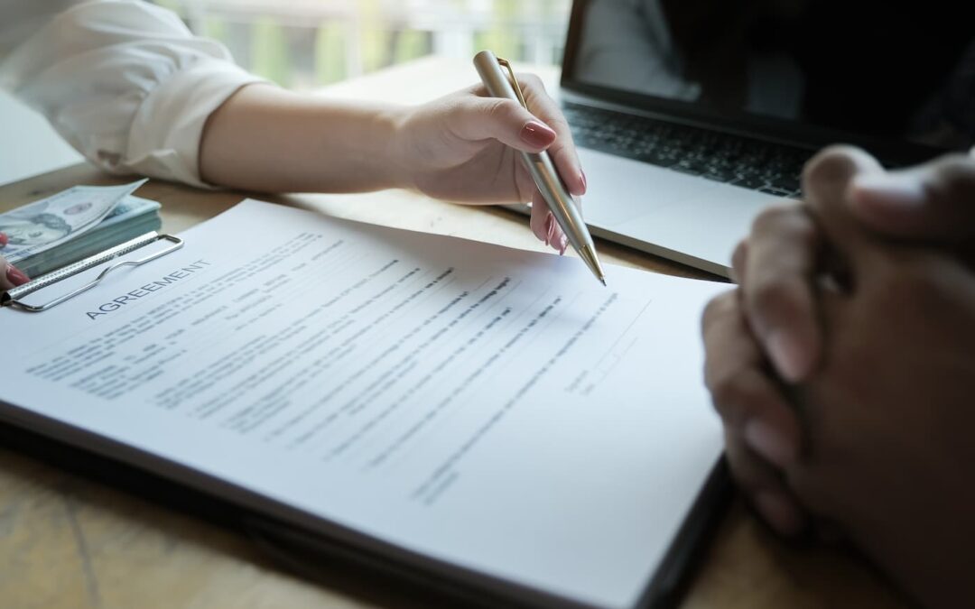 a picture of two people signing a lease agreement